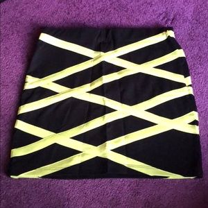 Black mini skirt with lime green stripes.